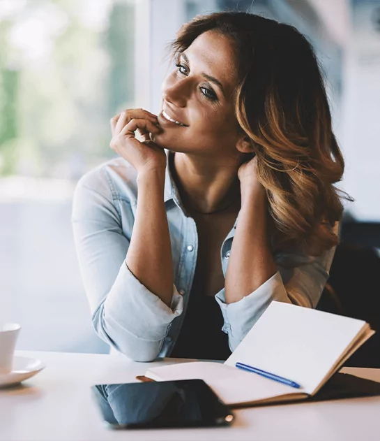 Creative writer at Prestige Publishings planning a book manuscript in a notebook.