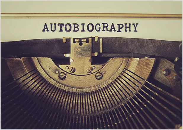 Close-up of a vintage typewriter with the word "AUTOBIOGRAPHY"