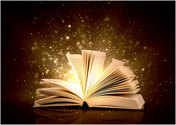 An open book with glowing golden sparkles rising from the pages against a dark background, symbolizing the magic of storytelling and professional publishing services.